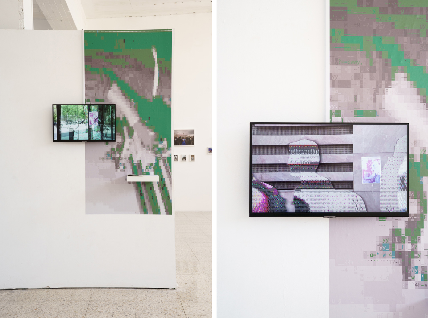 Two gallery walls, each with a wall-mounted screen playing video next to a large print of pixelated glitch patterns